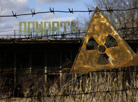 A radioactive sign hangs on barbed wire outside a café in Pripyat.