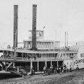 A historic picture of a steam paddleboat.