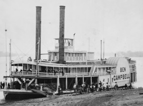 A historic picture of a steam paddleboat.