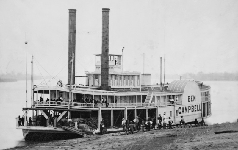 A historic picture of a steam paddleboat. 