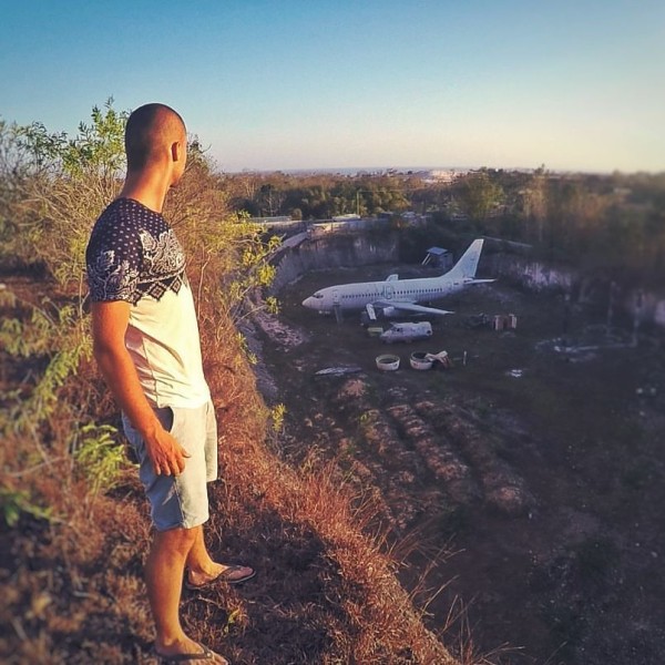 Jacob Laukaitis looks at a plane in a quarry in Bali